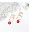 Gold-tone earrings WITH bird on a geometric frame & bold red circular accents.