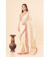 tissue silk saree in a soft golden hue featuring delicate red border 