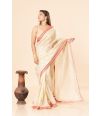 tissue silk saree in a soft golden hue featuring delicate red border 